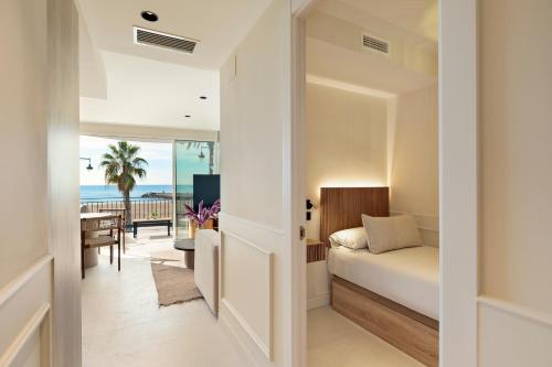 a bedroom with a bed and a view of the beach at Sitges Group Ocean in Sitges
