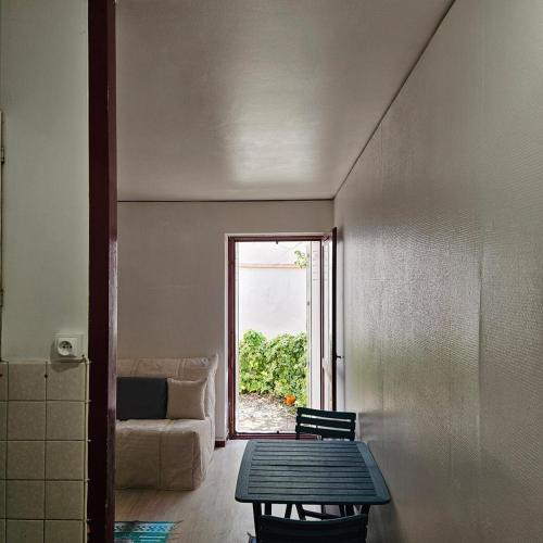 un salon avec une table et un canapé dans l'établissement Studio calme avec petit jardinet, à Bordeaux