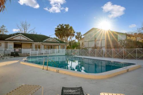 a swimming pool in front of a house at Sanctuary Gainesville Bright 2 BR King Condo in Gainesville