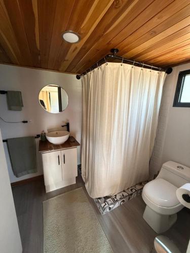 a bathroom with a toilet and a sink at Casa Morpho, Modern Studio with Unique Waterfall Views in Barú