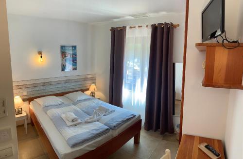 Ένα ή περισσότερα κρεβάτια σε δωμάτιο στο Hotel La Bastide