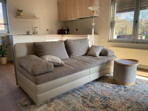 a living room with a couch in a kitchen at Het Kabinet in Munsterbilzen