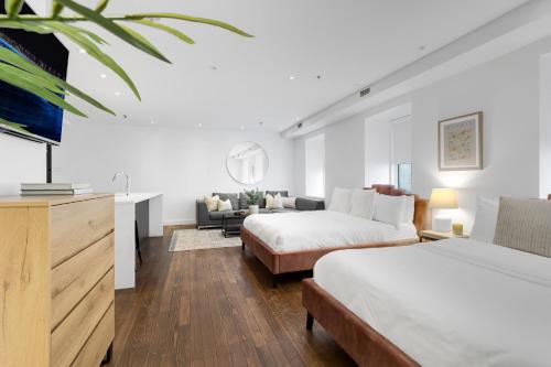 a bedroom with two beds and a living room at The SFX Old Port in Montréal