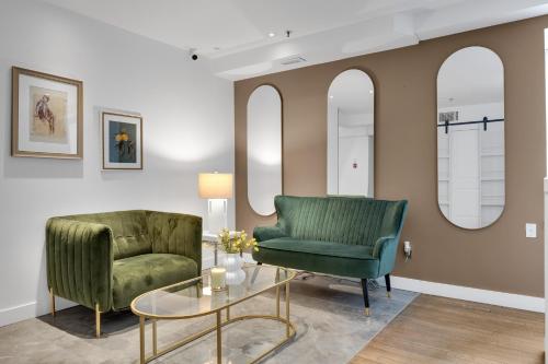 a living room with two green chairs and a table at The SFX Old Port in Montréal