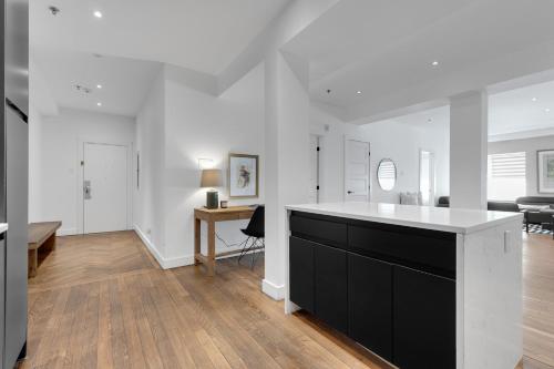 a kitchen with a black and white island in a room at The SFX Old Port in Montréal