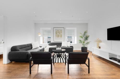 a living room with a couch and a table and chairs at The SFX Old Port in Montréal