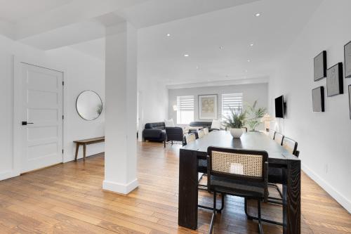a dining room and living room with a table and chairs at The SFX Old Port in Montréal