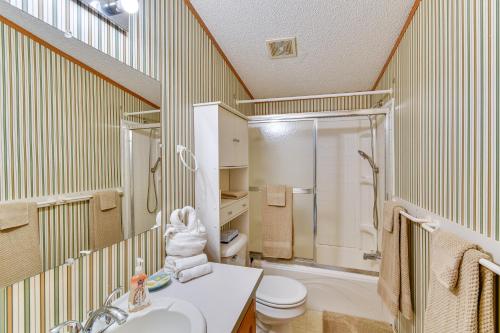 a bathroom with a sink and a toilet and a shower at Waterfront Home with Boat Slips in Northern Michigan in Gladwin