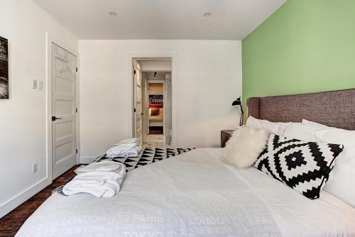 a bedroom with a large bed with white sheets at The SFX Old Port in Montréal