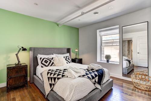 a bedroom with a large bed and a mirror at The SFX Old Port in Montréal