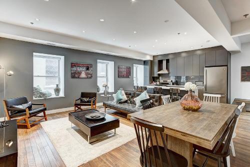 a living room with a table and a kitchen at The SFX Old Port in Montréal