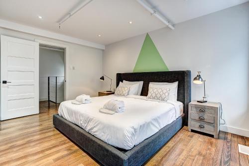 a bedroom with a large bed with a green wall at The SFX Old Port in Montréal