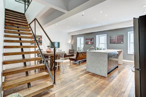 a kitchen and living room with a staircase in a house at The SFX Old Port in Montréal