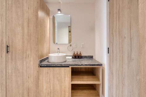 a bathroom with a sink and a mirror at Myla Chapultepec in Mexico City