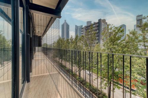 a balcony with a view of a city at Myla Chapultepec in Mexico City