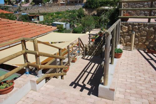 a group of tables on a brick walkway at Hotel Giardino delle Palme in Campese