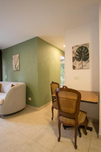 a living room with a couch and a table and chairs at Edificio Fenicia Lofts Laureles in Medellín