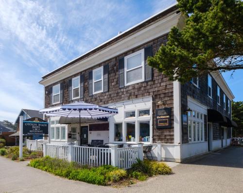 a building with an umbrella in front of it at Cannon Beach Hotel Collection in Cannon Beach