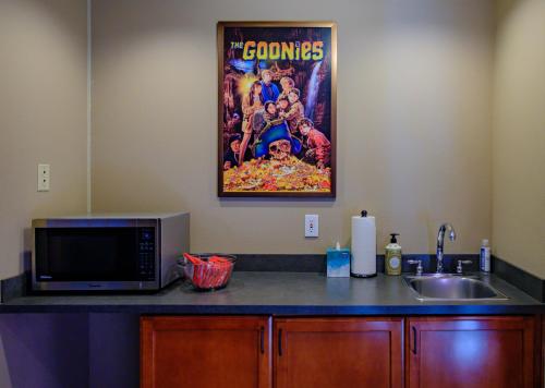 a kitchen with a sink and a movie poster on the wall at Cannon Beach Hotel Collection in Cannon Beach