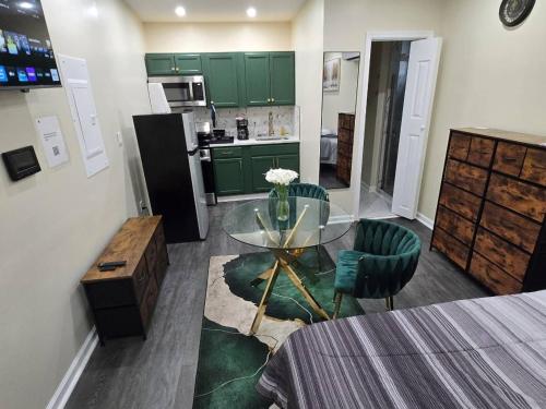 a kitchen with a glass table and green cabinets at G O G Building in Darby