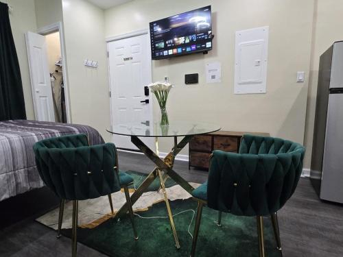 a room with a glass table and two chairs at G O G Building in Darby