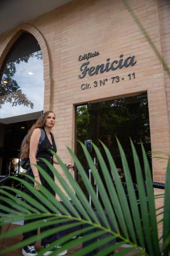 a woman is walking in front of a store at Edificio Fenicia Lofts Laureles in Medellín