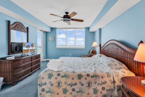 a bedroom with a bed and a ceiling fan at LAG902 Laguna Keys Oceanfront 4BR/3B Condo in Cherry Grove in Myrtle Beach