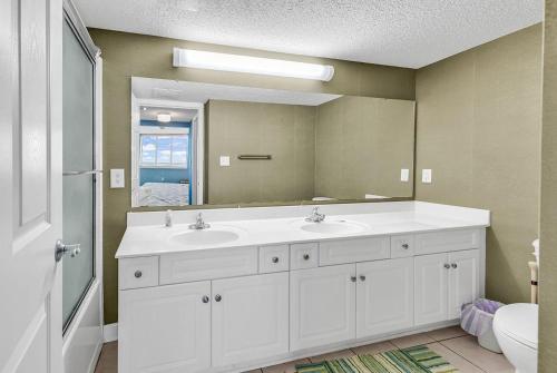 a bathroom with two sinks and a large mirror at LAG902 Laguna Keys Oceanfront 4BR/3B Condo in Cherry Grove in Myrtle Beach