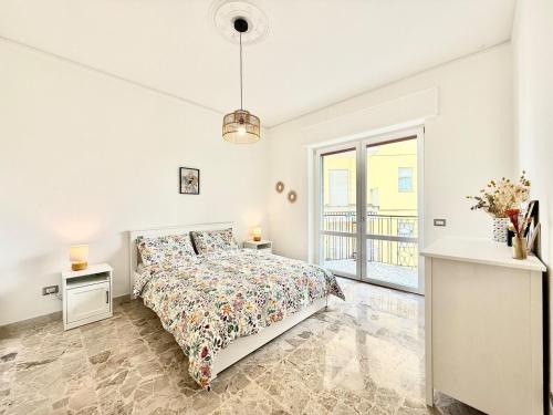 a white bedroom with a bed and a window at Casa Miró in Arona