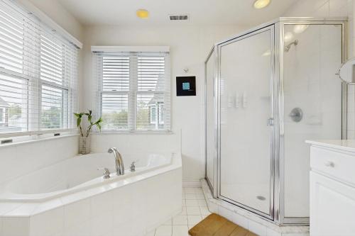 a white bathroom with a tub and a shower at Bethany Crossing - 322 Garfield in Bethany Beach