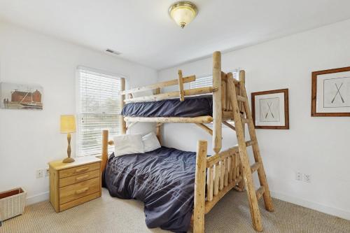a bedroom with a bunk bed with a ladder at Bethany Crossing - 322 Garfield in Bethany Beach