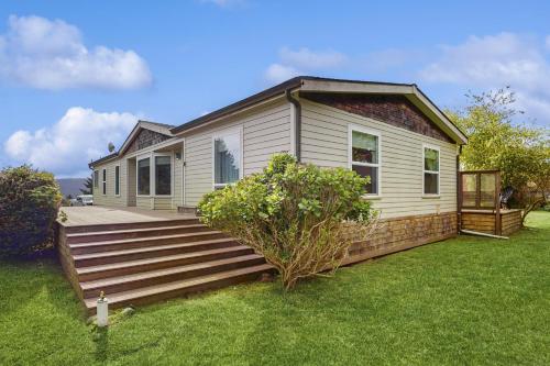 a house with a wooden deck in the yard at Pacific View Escape in Loleta