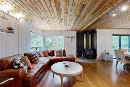 a living room with a couch and a table at Tree House in Sea Ranch