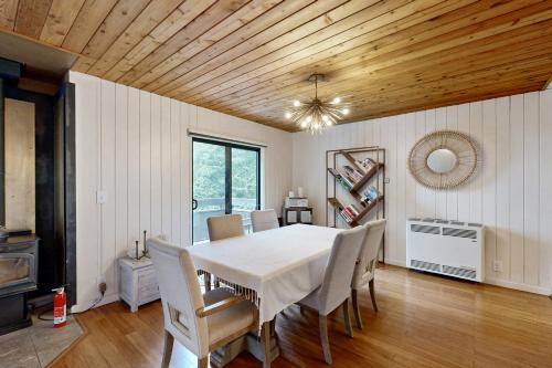 a dining room with a white table and chairs at Tree House in Sea Ranch