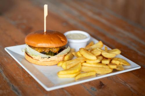 a sandwich and french fries on a plate with sauce at House Boat s výhledem na Wake Port in Brandýs nad Labem-Stará Boleslav