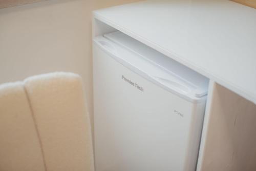 a white drawer in a white cabinet in a room at La finestra sugli ulivi in Pezze di Greco