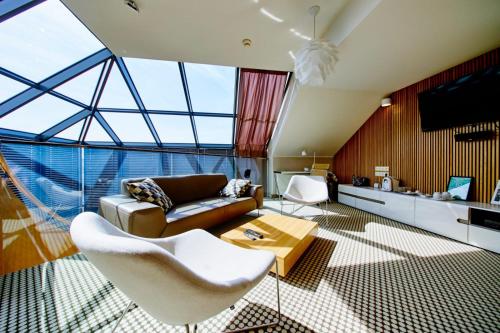 a living room with a couch and a table at Hotel Great Polonia Velvet Suwałki in Suwałki