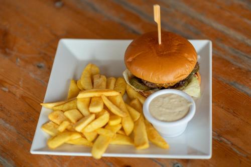 a plate with a hamburger and french fries and dip at House Boat s výhledem na Wake Port in Brandýs nad Labem-Stará Boleslav