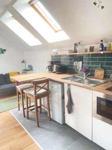 - une cuisine avec un comptoir en bois et une table dans l'établissement Entre terre et mer, à Montfarville