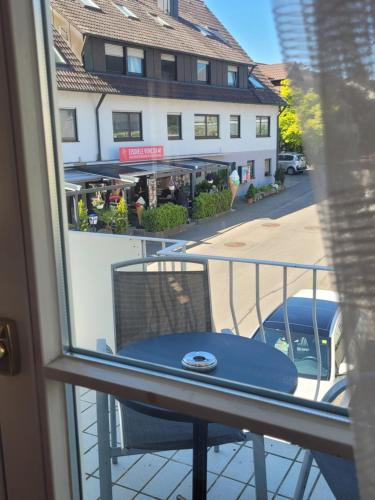 a balcony with a table and a view of a street at SEE-Hotel Seeschau - direkt am Bodenseeufer in Reichenau