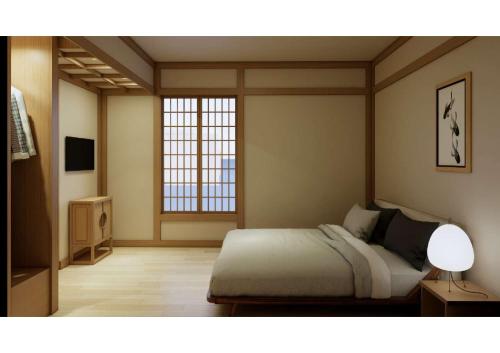 a bedroom with a bed and a window at The Ryokan Semarang in Semarang