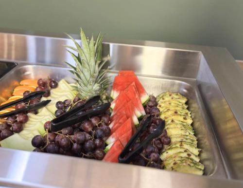 a tray of fruits and vegetables on a buffet at Hotel des Eskers in Amos