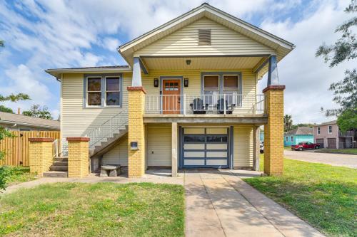 a yellow house with a blue garage at 2 Mi to Pleasure Pier Pet-Friendly Gem with Yard in Galveston