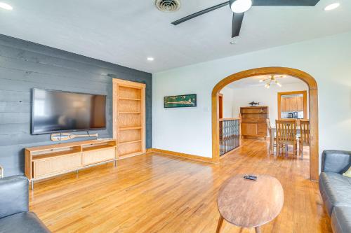 a living room with a couch and a flat screen tv at 2 Mi to Pleasure Pier Pet-Friendly Gem with Yard in Galveston