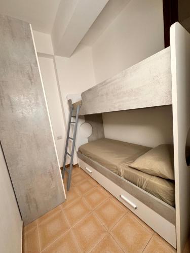 a bunk bed in a small room with a ladder at Casa vacanza Stella in Torre Forte