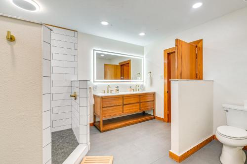 a bathroom with a toilet and a sink at 2 Mi to Pleasure Pier Pet-Friendly Gem with Yard in Galveston