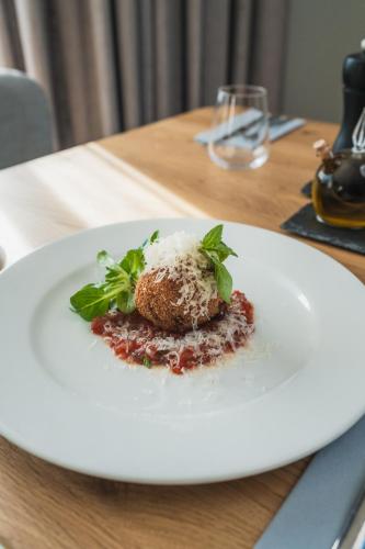 a white plate with a dessert on a table at Resort - D9 in Želnava