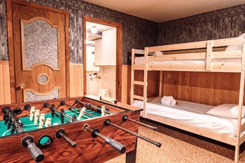 a room with two bunk beds and a pool table at Sous Bois & Loft - Hot tub - Ski out in Mont-Blanc