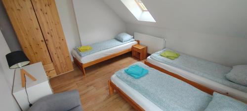 a small room with two beds and a window at Agroturystyka Huculska Polana in Regetów