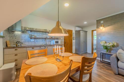 a kitchen and dining room with a table and chairs at Tesla's Gastro House Plitvice in Plitvička Jezera